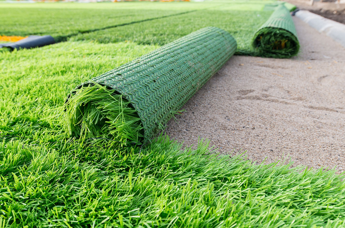 Artificial Grass being installed in a garden